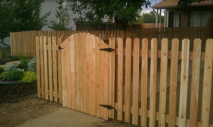 Picket fence with an arched walk gate